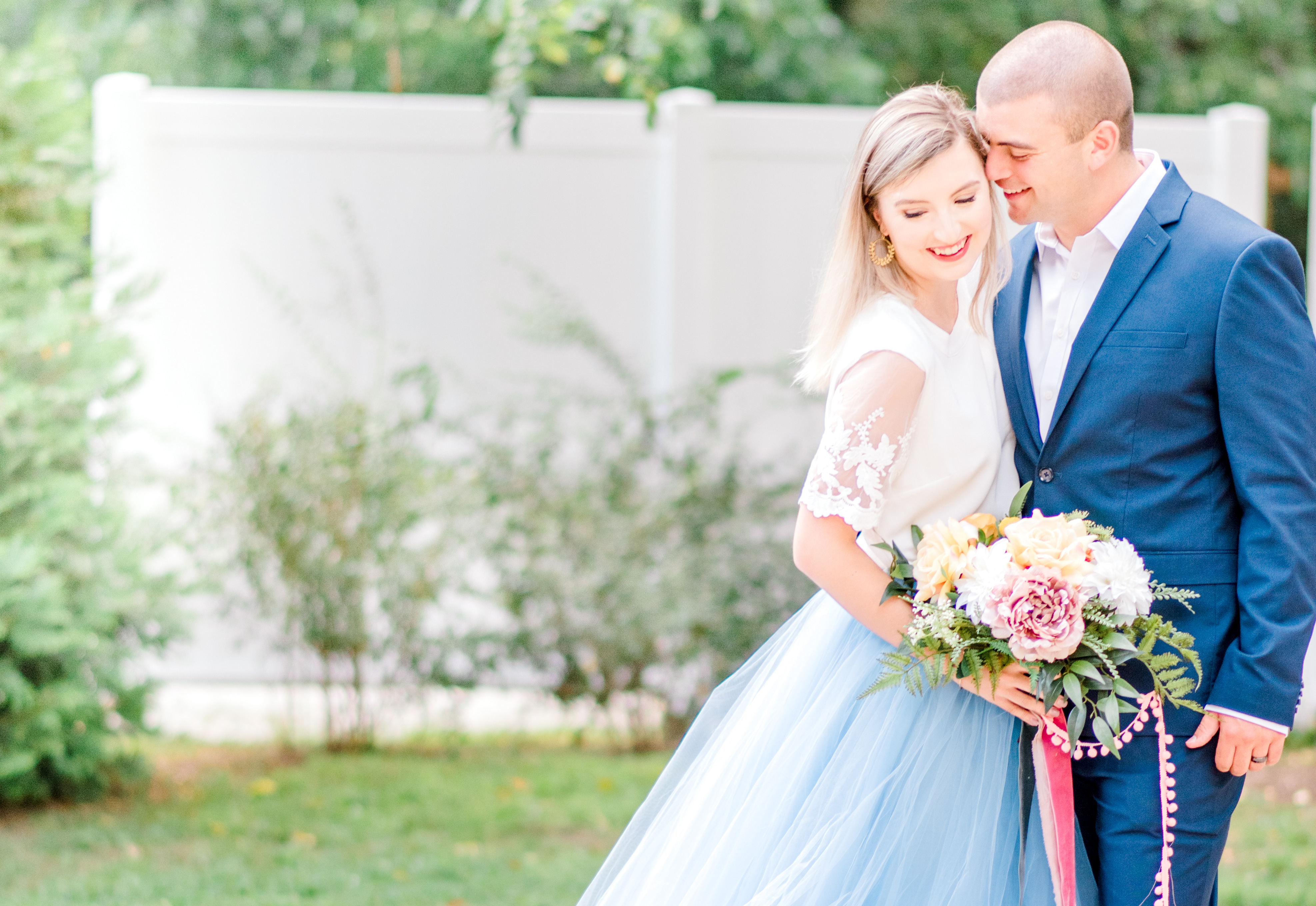 Engagement couple shoot with woman with blue puffy skirt and shirt shirt with her fiancé wearing a blue suit